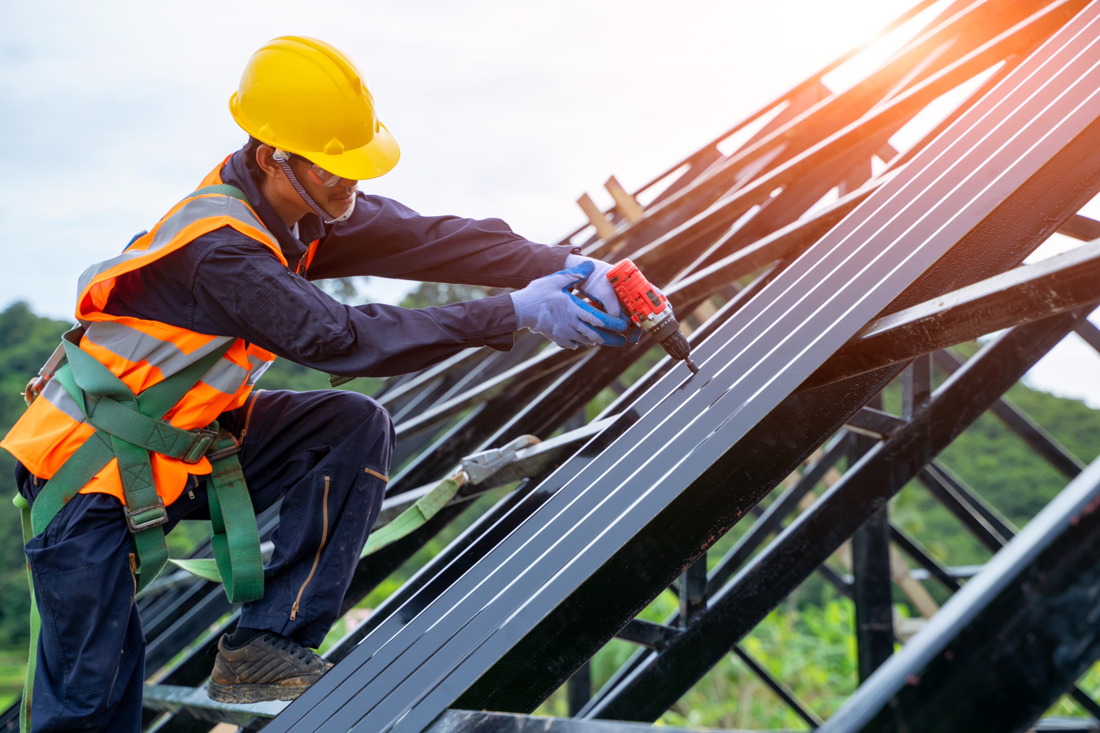 Worker in PPE installing steel components on-site
